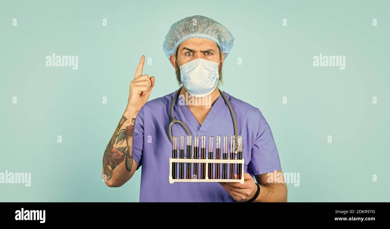 Quarantine plans. Epidemic threshold. Medical research. Man in medical lab inspecting samples biological material. Test tubes. Epidemic disease. Virus concept. Epidemic infection. Hospital treatment. Stock Photo