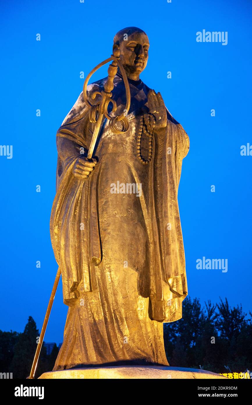 Large statue of Xuanzhuang Xuanzang in Xian city park lit at night Stock Photo