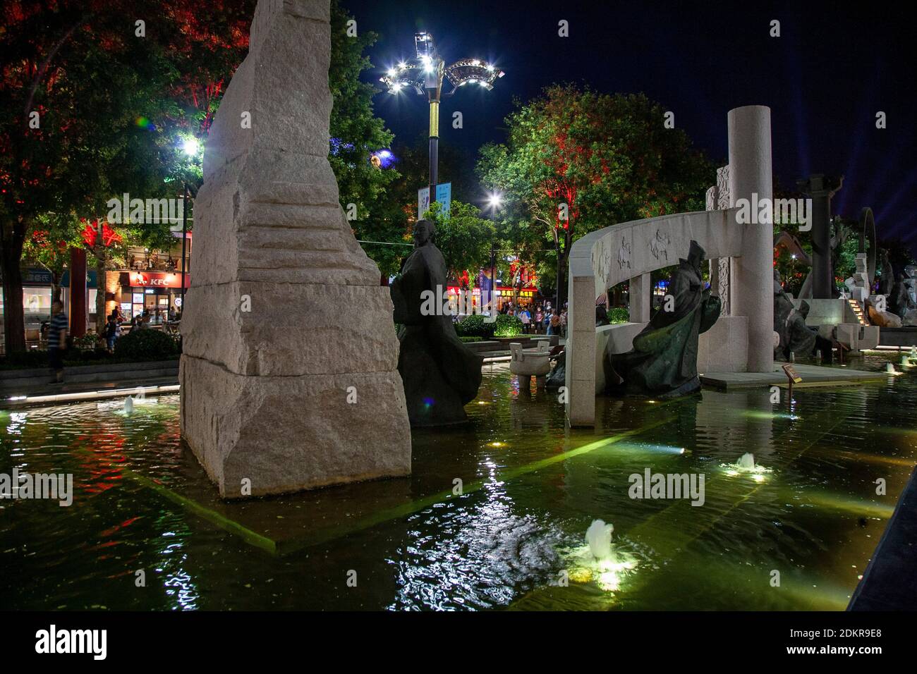 Statues and water feature in evening at Xian Park Xi'an Night Stock Photo