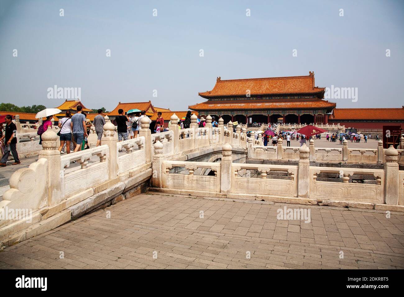 Tourists cross bridge over Golden Stream in First courtyard within Imperial Forbidden City Beijing Stock Photo