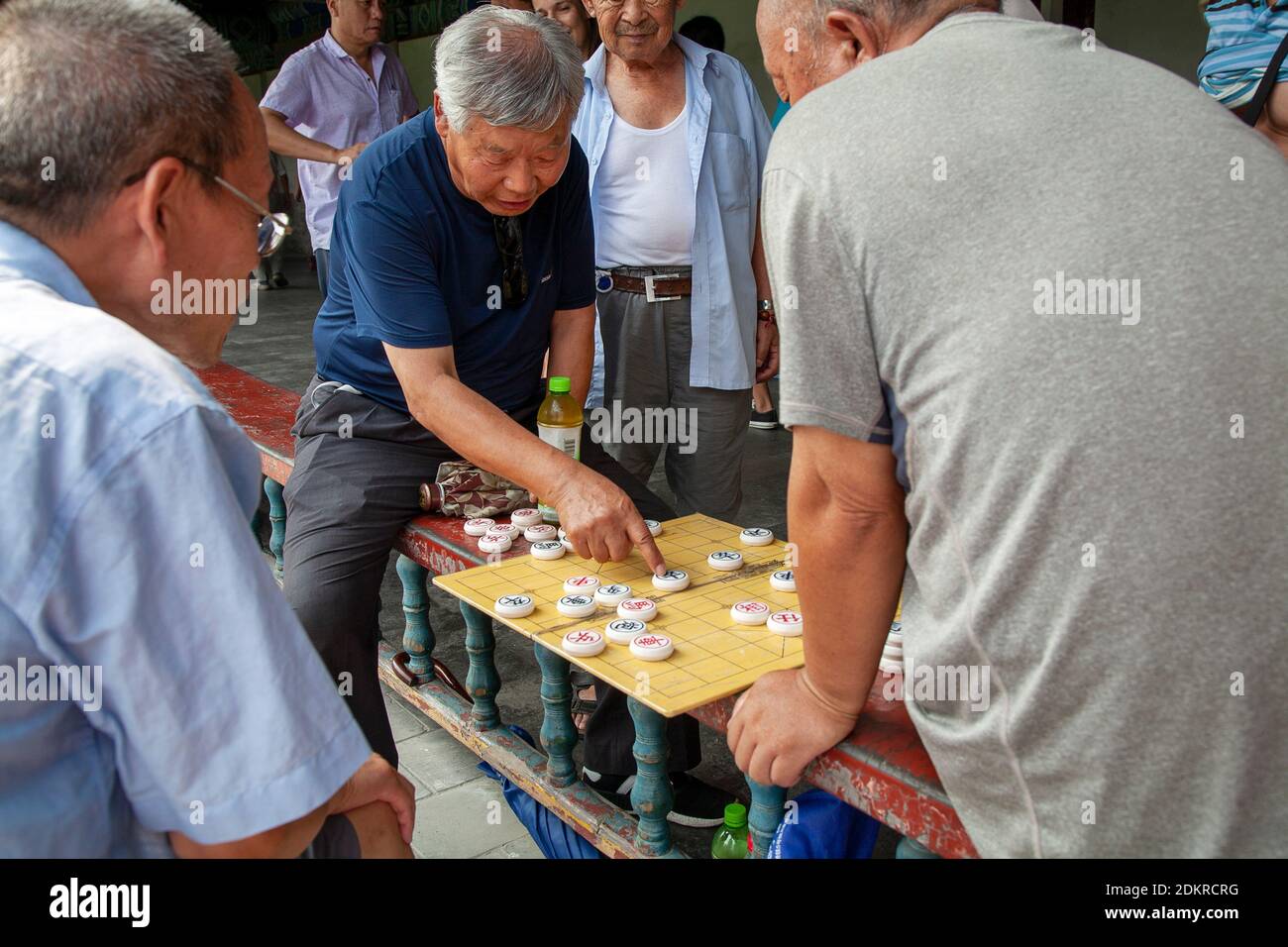 Older men playing traditional Chinese Checkers game in gardens of Temple of Heaven Beijing Stock Photo