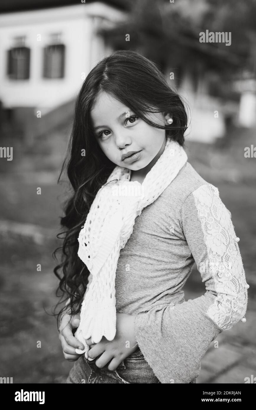 Portrait Of Cute Girl With Long Hair Standing On Land Stock Photo - Alamy