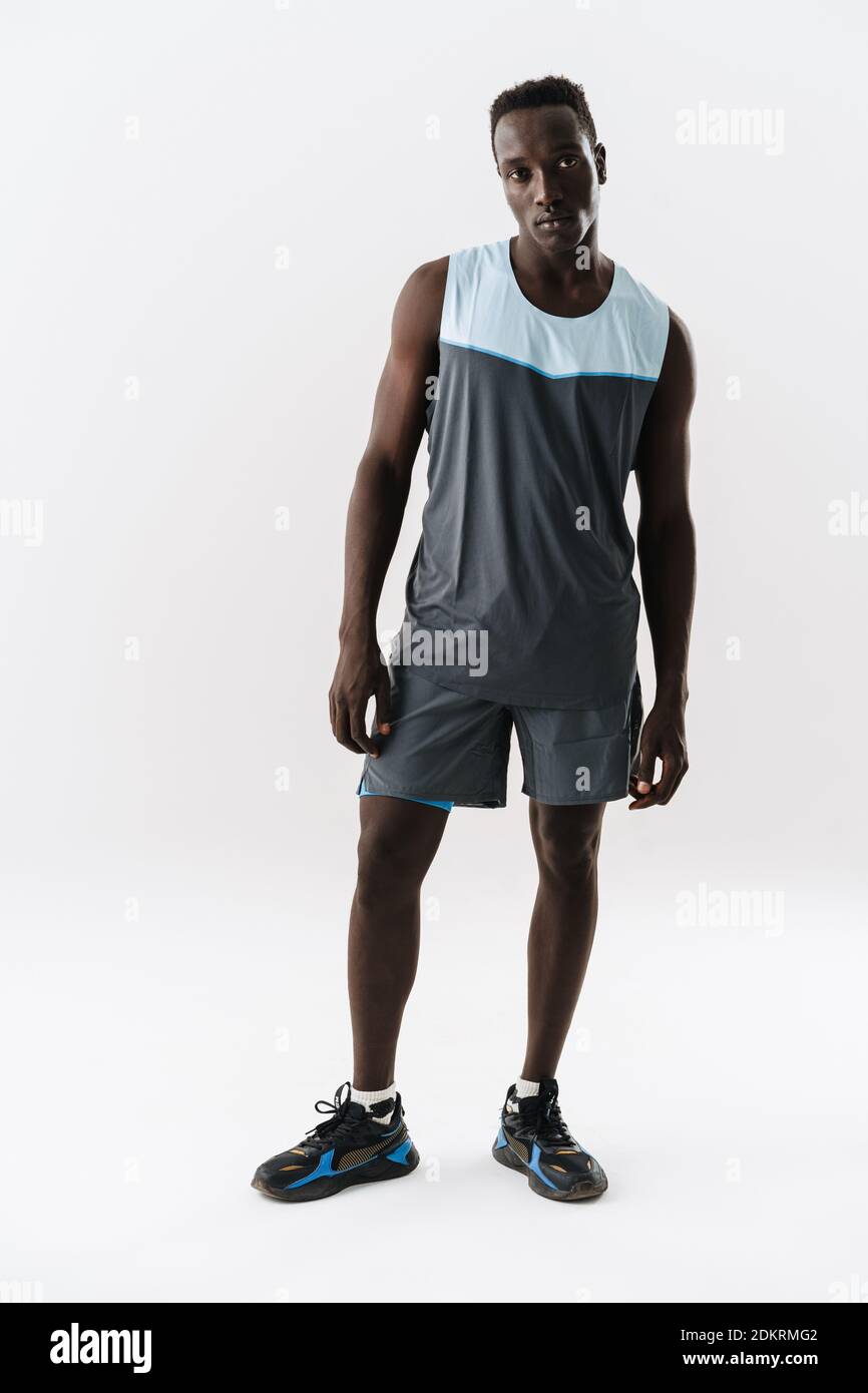 Young athletic african american sportsman posing and looking at camera ...