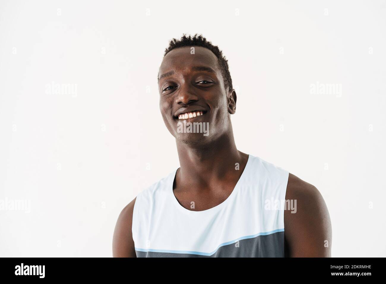 Happy athletic african american sportsman smiling and looking at camera ...