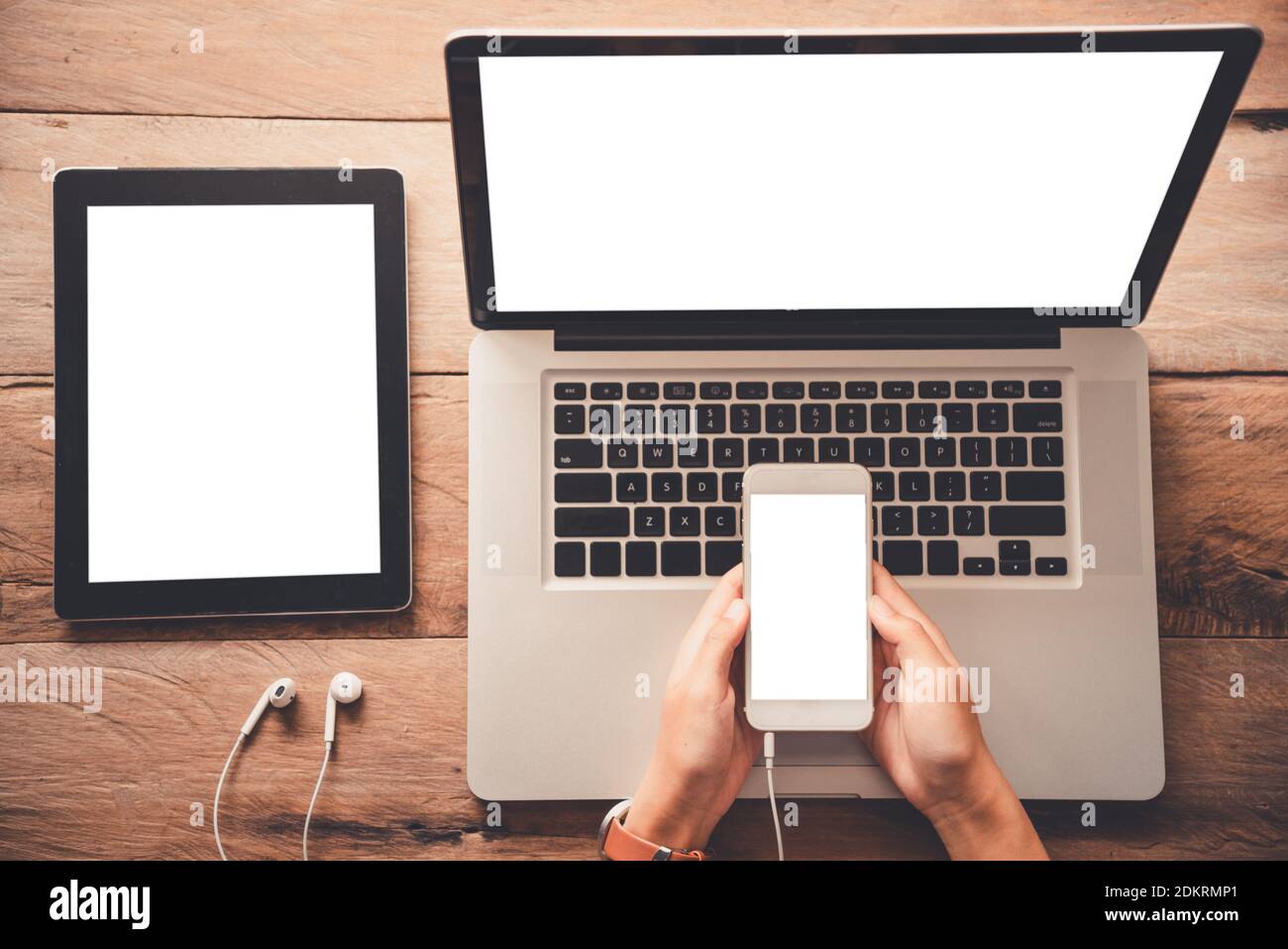 High Angle View Of Person Using Smart Phone Over Laptop On Table Stock  Photo - Alamy