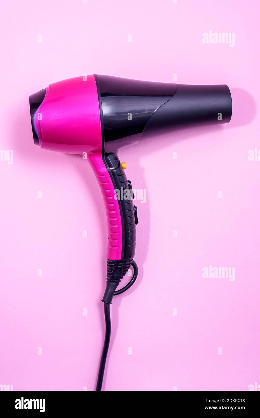 Black and Pink Hairdryer on light pink background - hairstyle tool Stock  Photo - Alamy