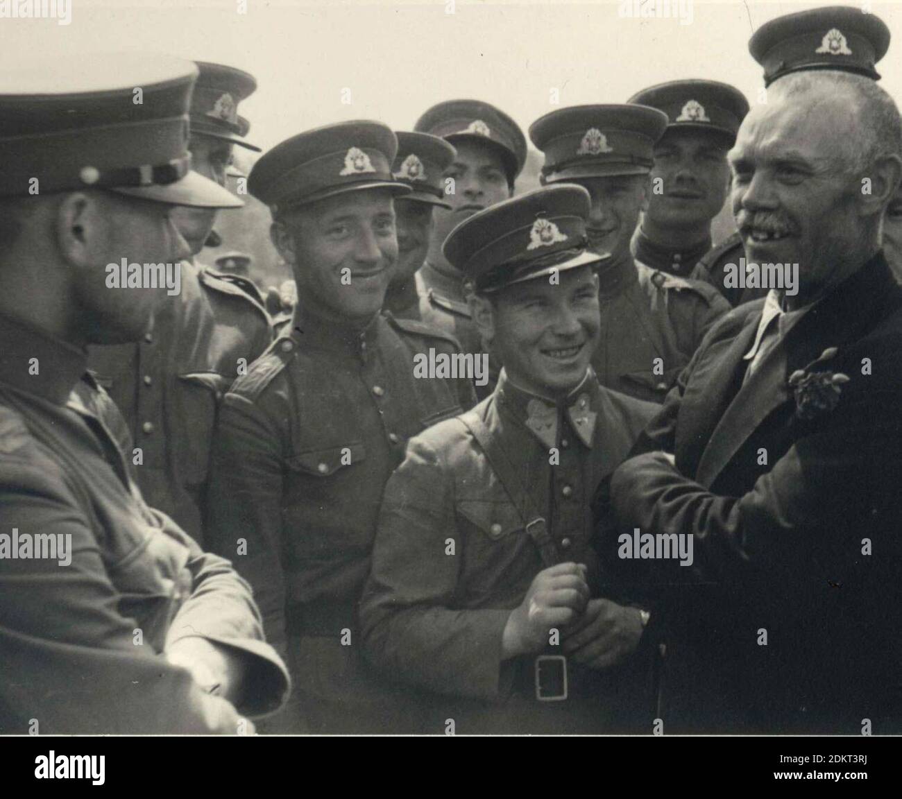 Soviet political leader (without military shoulder straps) and the People's Seimas member (with red rose in his jacket lapel) announces to the Lithuanian People's Army non-commissioned officers that 'soon you will become members of the Red Army' in Kaunas, 1940 Stock Photo