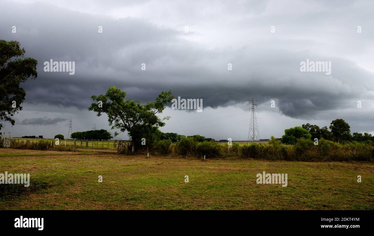 Energy plant in the field. Grey clouds. Storm is coming Stock Photo