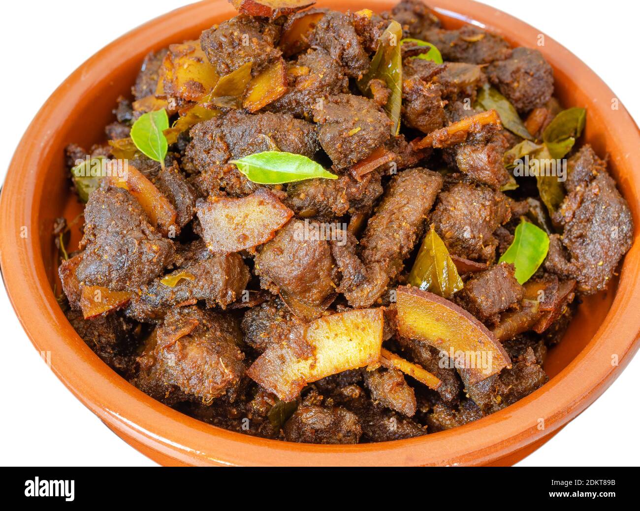 Kerala Special Beef Coconut Fry in a clay bowl in a traditional way - A Kerala Special Christmas Recipe - Isolated Stock Photo