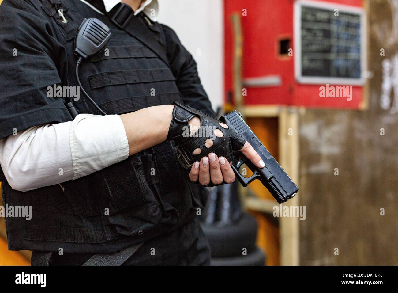 Midsection Of Police Holding Gun Stock Photo