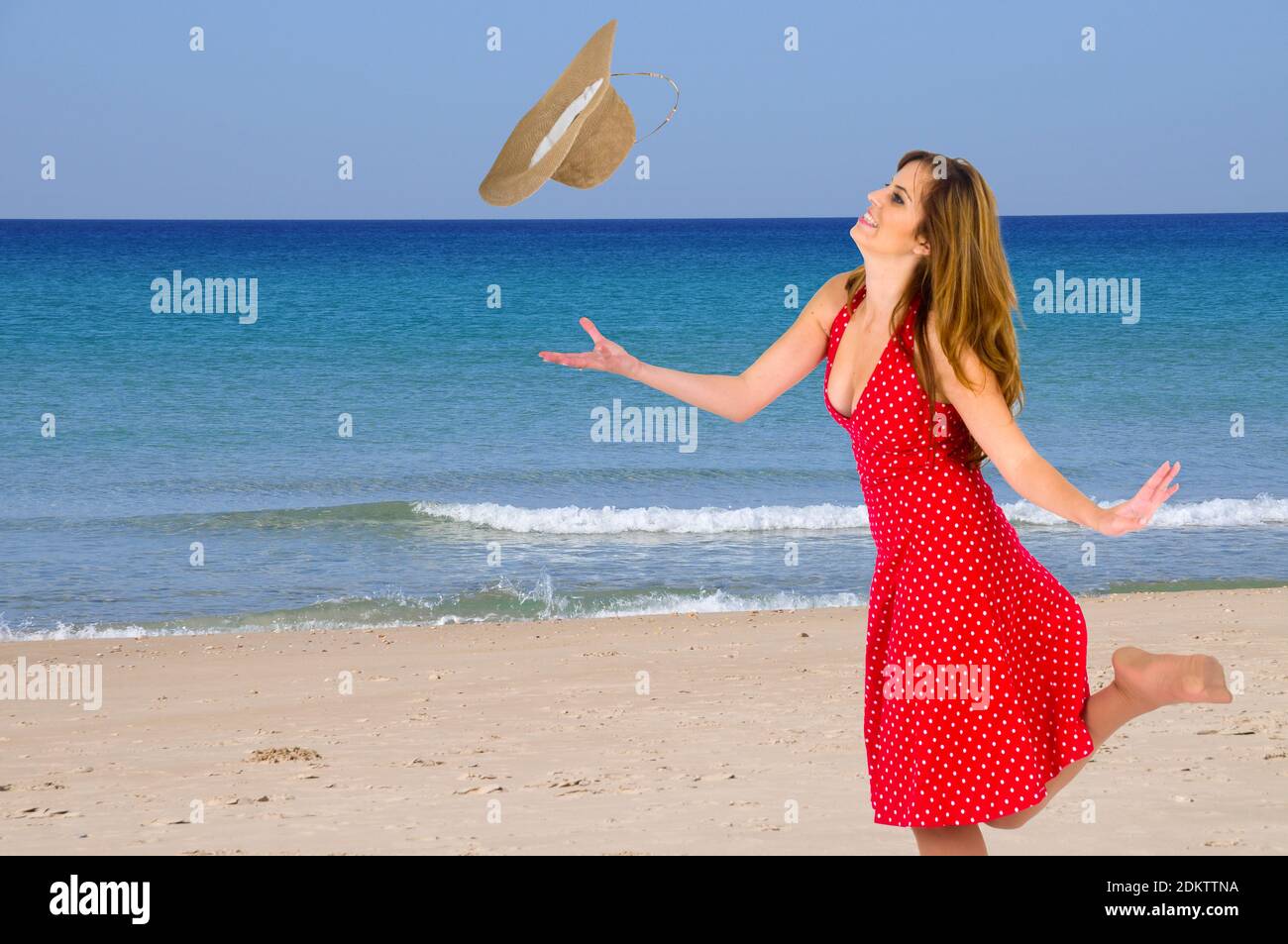 Young woman in summer dress and straw hat on the beach Stock Photo - Alamy