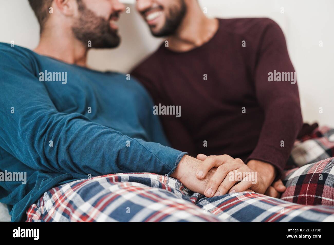 Gay men couple having tender moments together at home - Homosexual, love and relationship concept - Main focus on hands Stock Photo