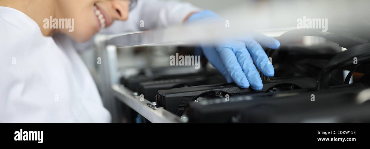 Female specialist assembling cryptocurrency mining farm closeup Stock Photo
