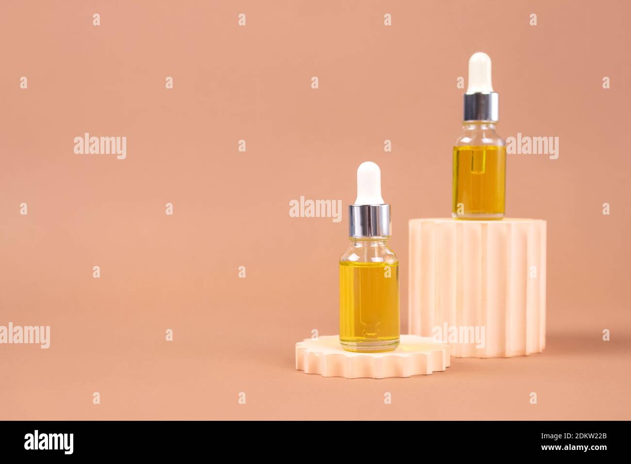 Mockup image of dropper bottle - natural organic cosmetics, hyaluronic acid, serum, moisturizer or facial anti-aging oil. Essential oil in trendy bieg Stock Photo