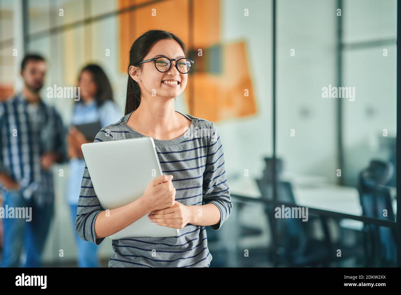 Cheerful young woman feeling happy while going to work Stock Photo