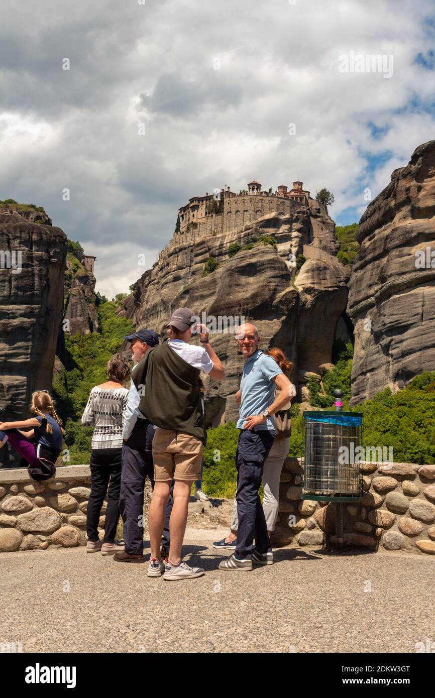 Kalambaka, Greece - May 02, 2019: Tourists and the Monastery of Great Meteoron at the background, Meteora, Greece. Stock Photo