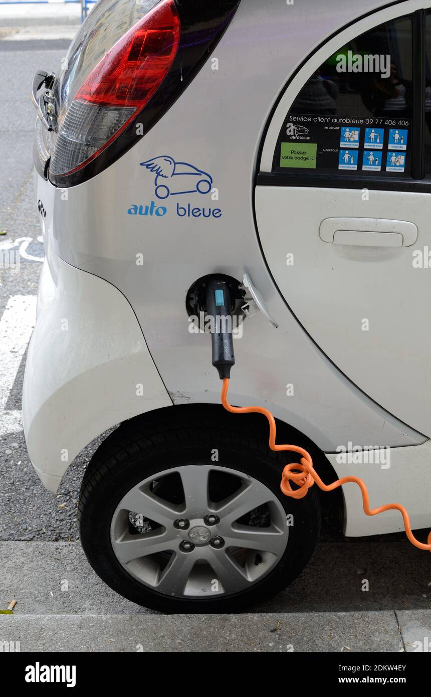 Charging Electric Car or Electric Vehicle at Roadside Electric or Electricity Pump Stock Photo