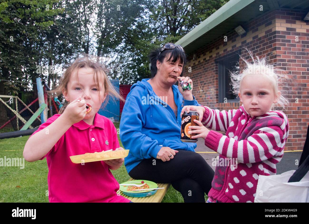 Knottingley,  UK – 04 Aug 2017 – A family enjoy the free hot lunch provided at The Addy, The Old Quarry Adventure Playground at Warwick Estate Stock Photo