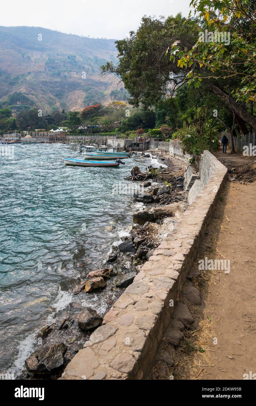 Pathway and wooden docks along lake Atitlan at the coast of Santa Cruz la Laguna, Guatemala Stock Photo