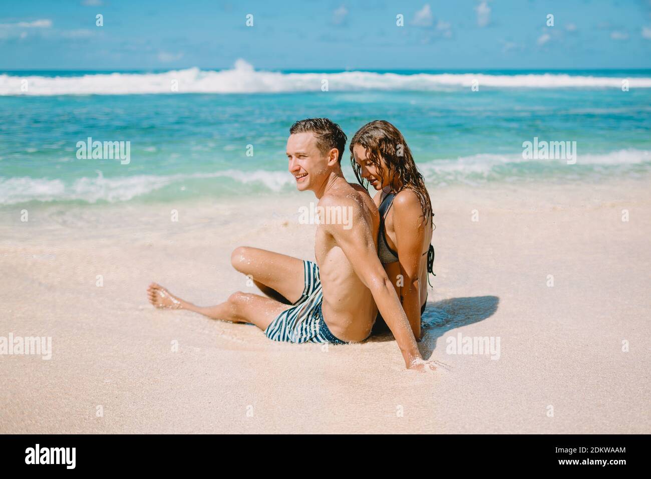 January 28, 2020. Bali, Indonesia. Happy young couple at tropical beach. Honeymoon in paradise luxury island Stock Photo