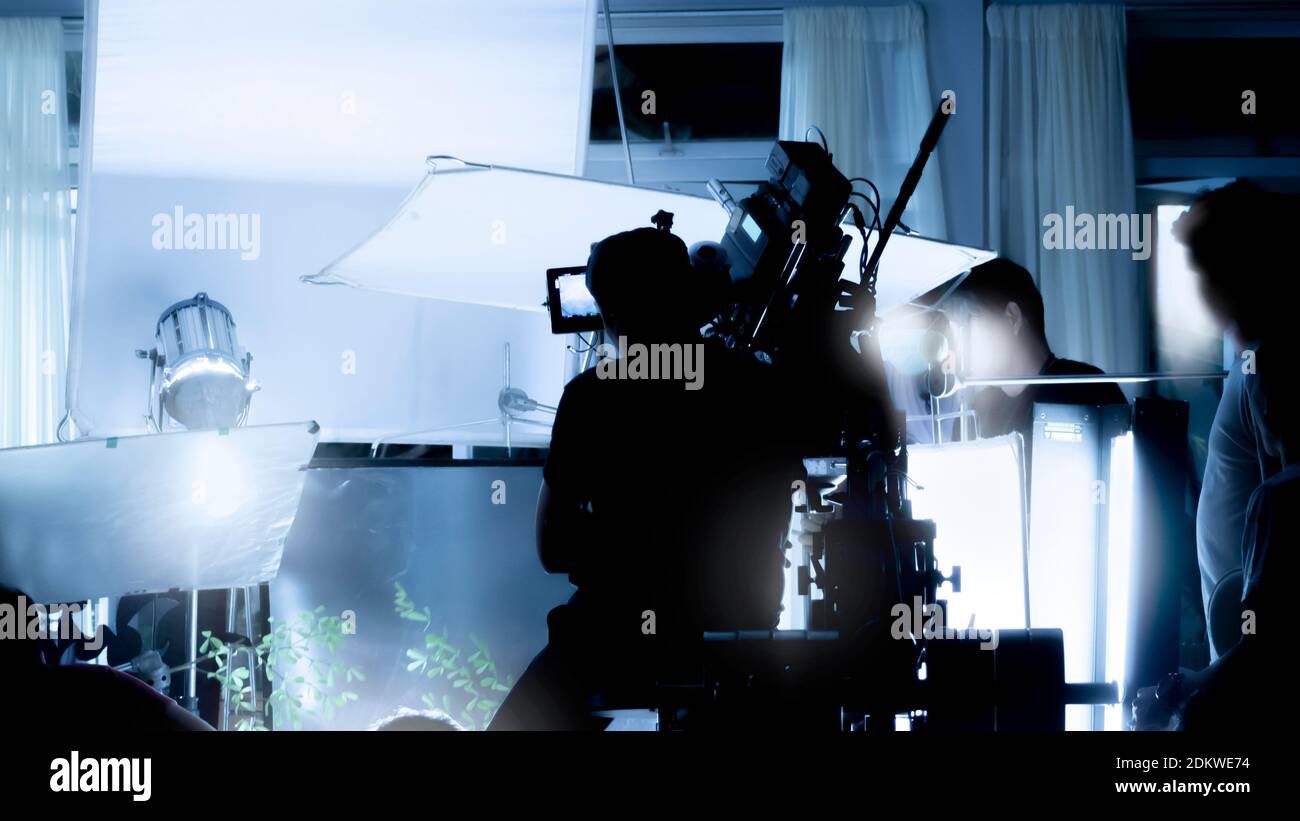 Silhouette images of video production behind the scenes or b-roll or making of TV commercial movies that film crew team lightman and videos cameraman Stock Photo