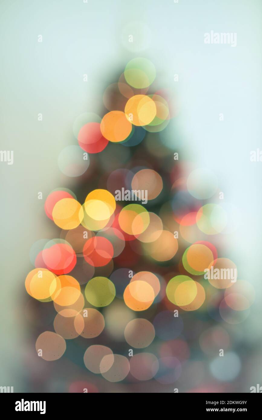 Defocused Christmas tree with lights in different colors Stock Photo