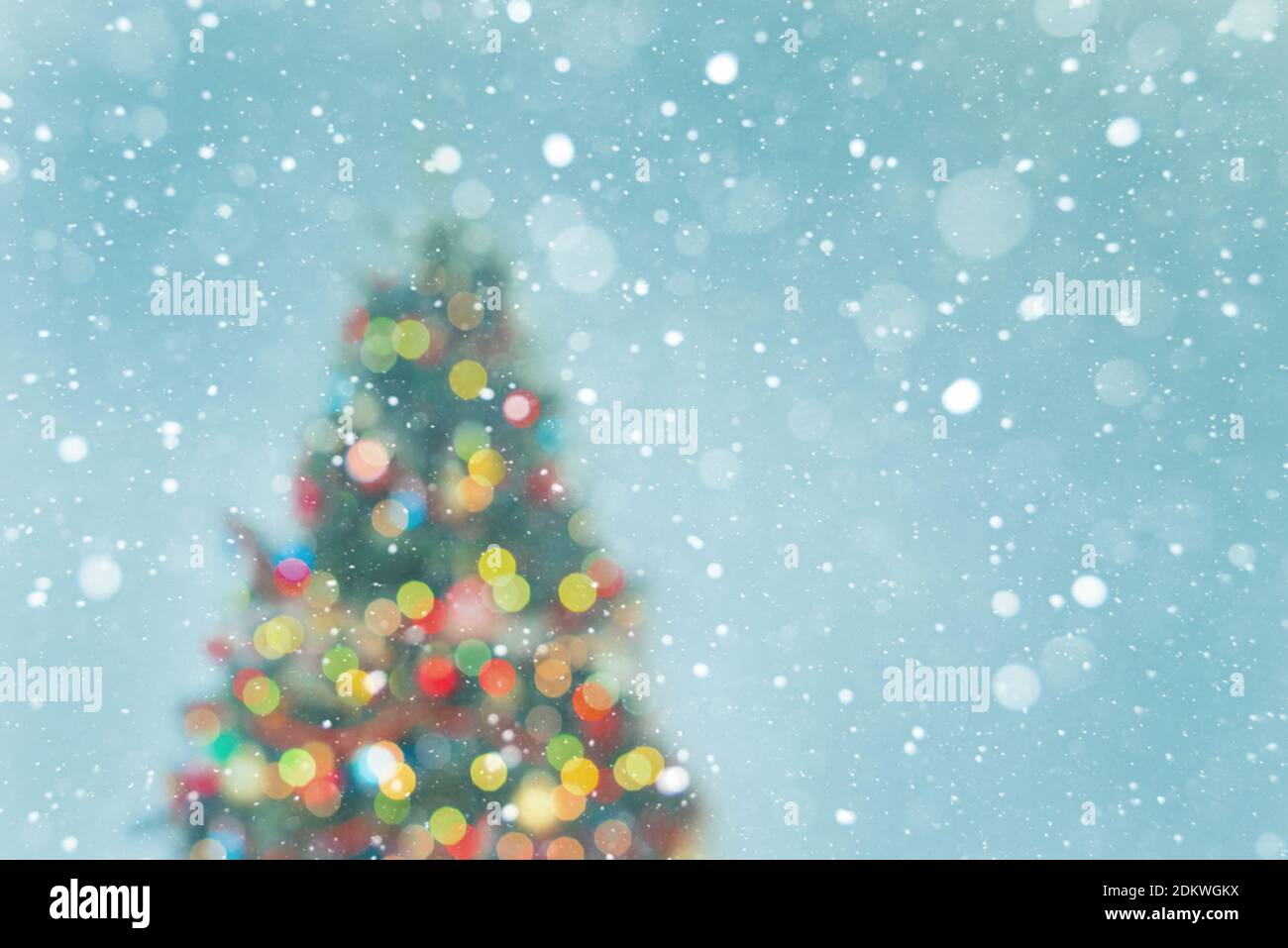 Christmas tree - blured lights and snowflakes on blue background Stock Photo