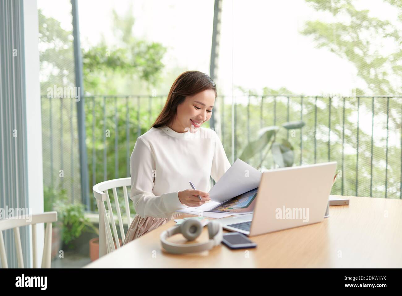 Focused young asian female entrepreneur deep in thought while working ...
