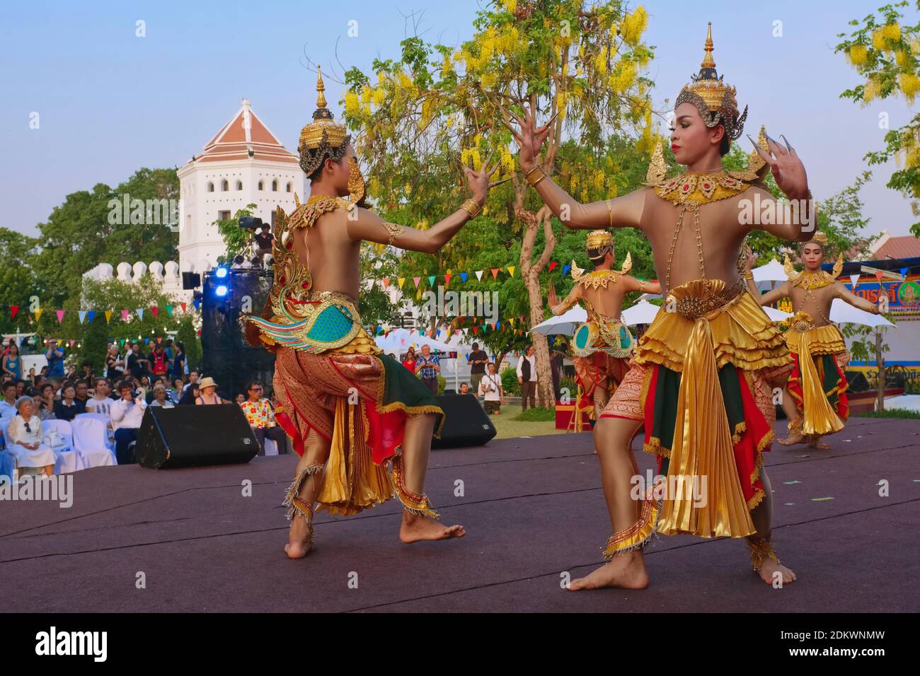 Male Thai dancers in traditional costume in an open-air performance of traditional Thai dance at Santichaiprakarn Park, Banglamphoo, Bangkok, Thailand Stock Photo