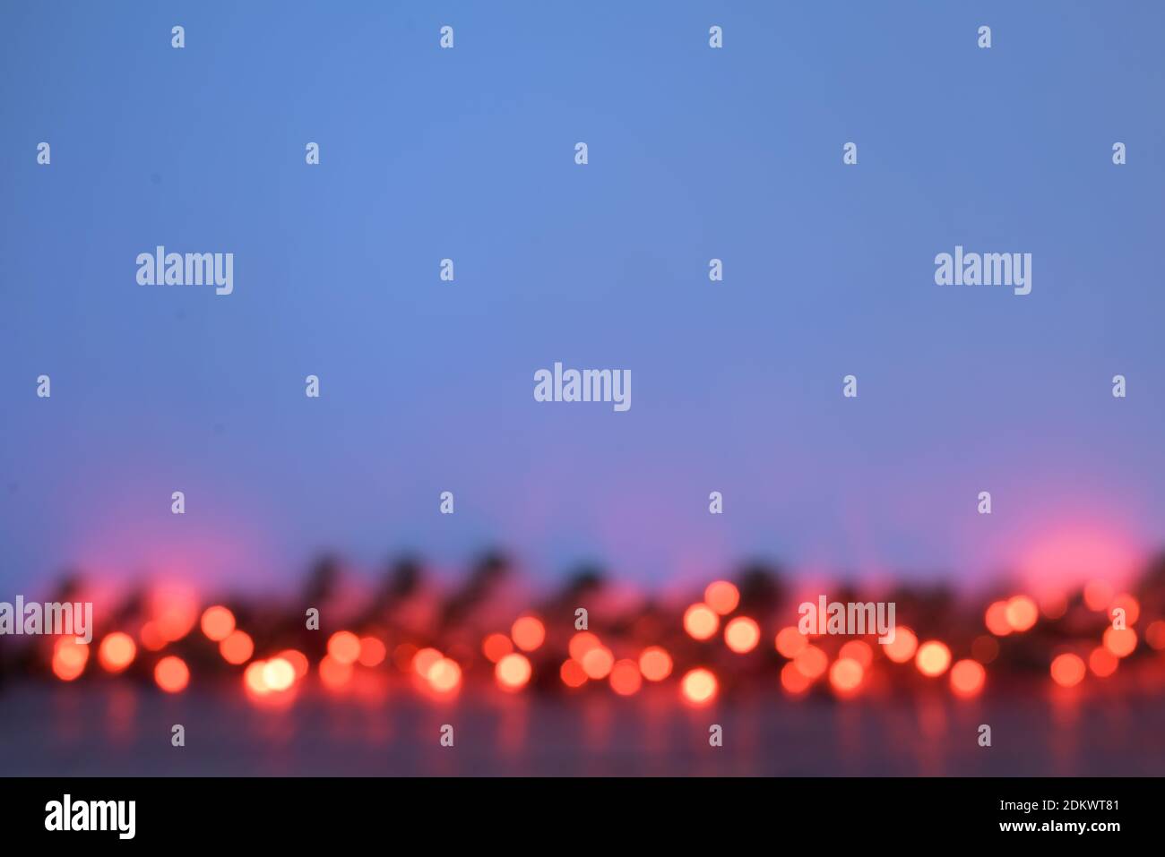 Defocused Christmas garland of red lights on a blue background Stock Photo