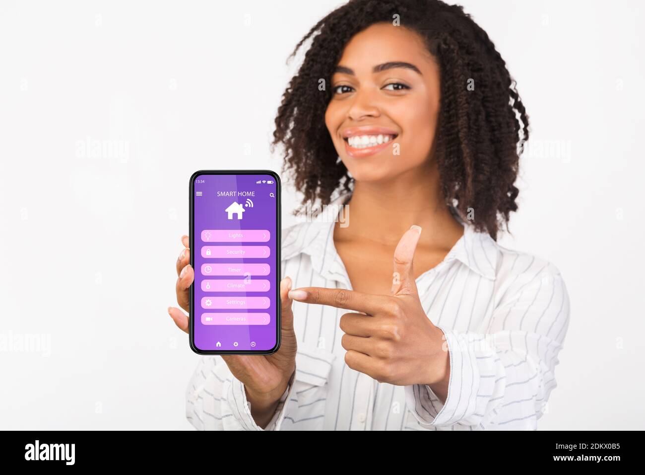 Collage of young black woman controlling appliances and devices, using modern smart home app on cellphone Stock Photo