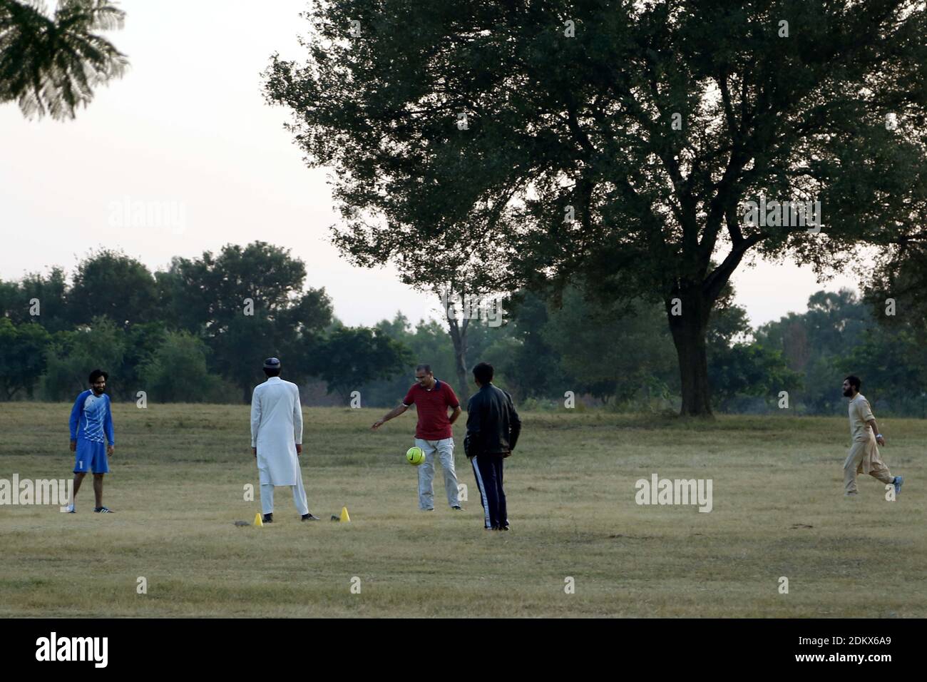 (201216) -- ISLAMABAD, Dec. 16, 2020 (Xinhua) -- Photo taken on Dec. 15, 2020 shows people playing football at Fatima Jinnah Park in Islamabad, capital of Pakistan. (Xinhua/Ahmad Kamal) Stock Photo