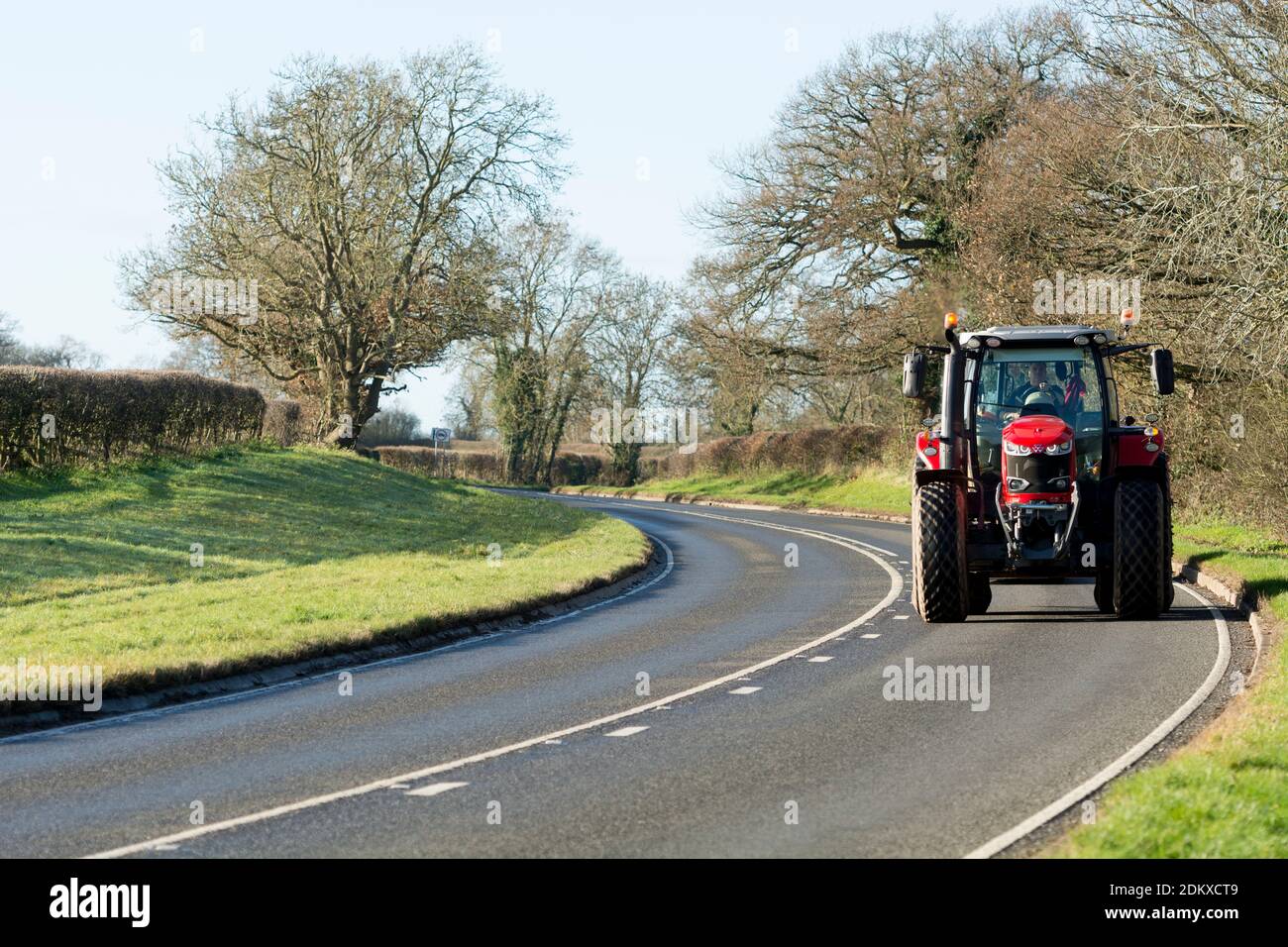 A Massey Ferguson tractor on a country road (A4189) near Warwick, Warwickshire, England, UK Stock Photo