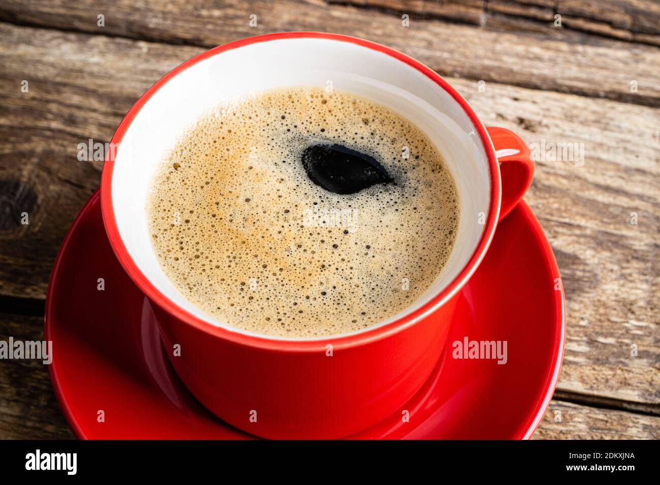 Coffee espresso in red cup. Coffee cup on wooden background closeup. Morning, breakfast, energy, coffee break concept. Top view Stock Photo
