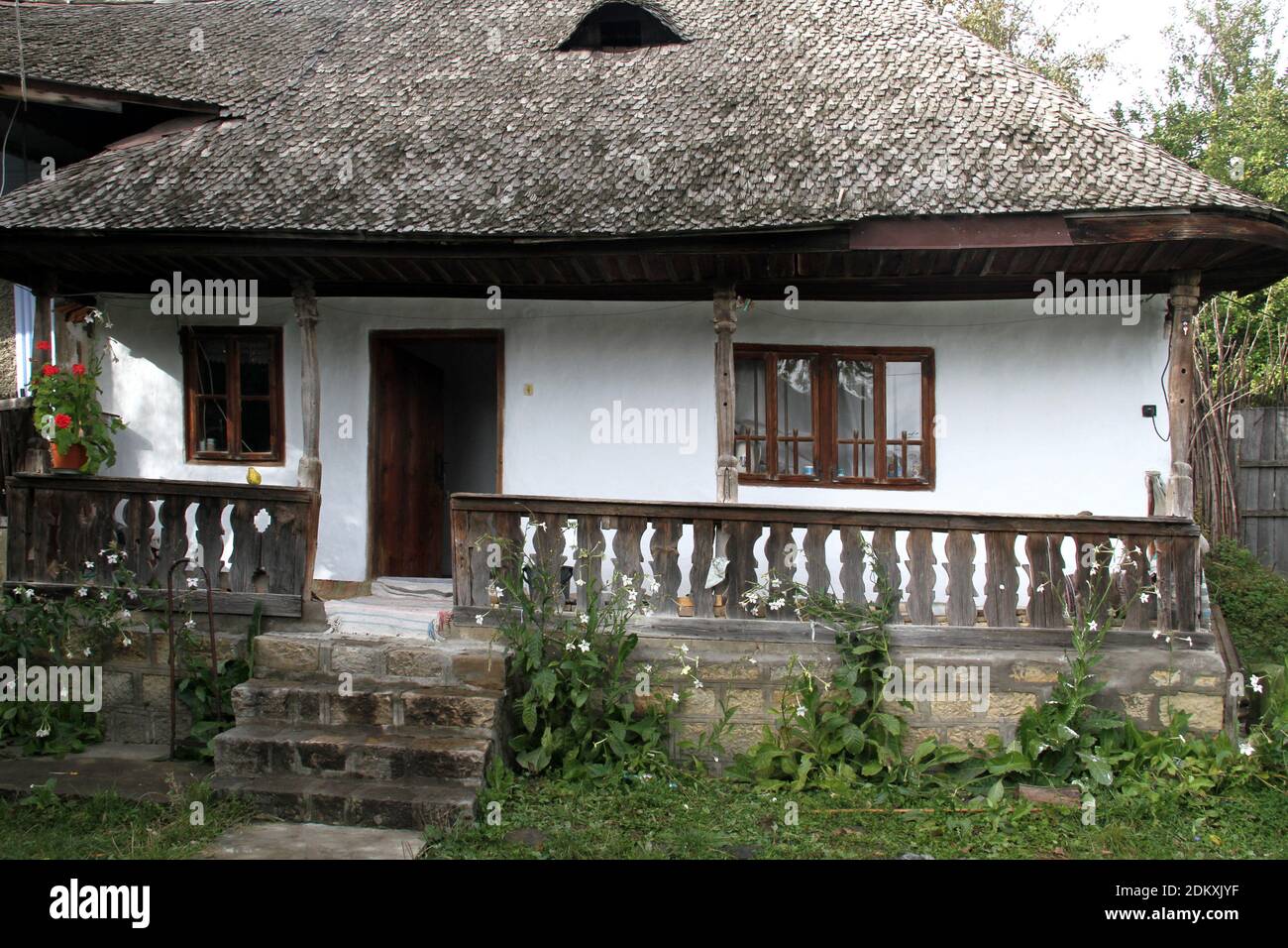 Vrancea County, Romania. Small traditional house with porch and wooden roof. Stock Photo