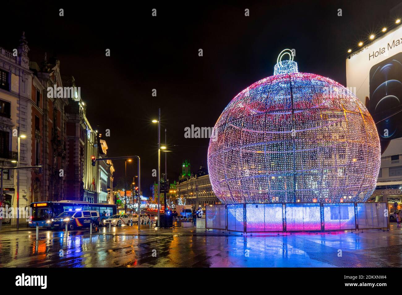 Madrid, Spain 2020 Madrid's giant Christmas bauble at dark night. Christmas urban light decoration in the capital of Spain. Illuminated attraction Stock Photo