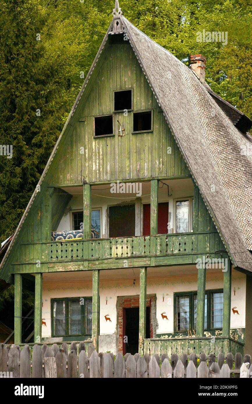 Vrancea County, Romania. Large house with steep wooden shingle roof and a wooden facade. Stock Photo