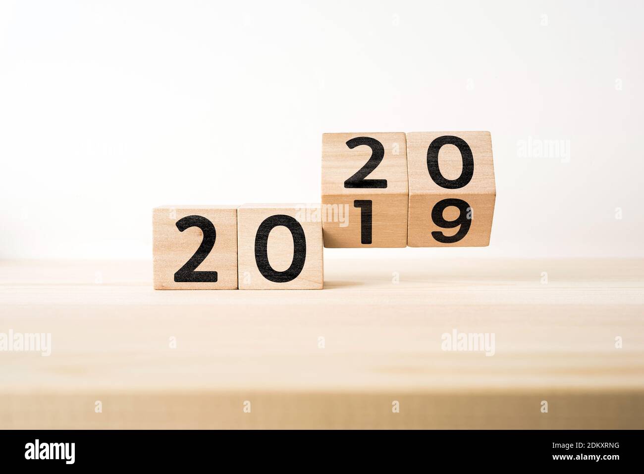 Close-up Of Wooden Blocks With 2019 2020 Number On Table Against White Background Stock Photo