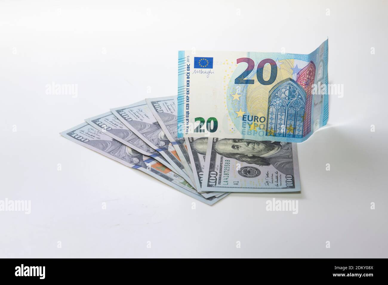 Twenty euro note on top of one hundred dollar bills Stock Photo