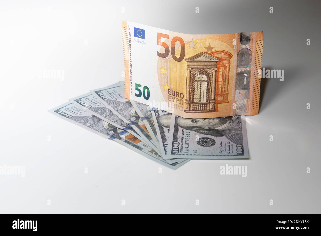 50 Euro note on top of one hundred dollar bills Stock Photo