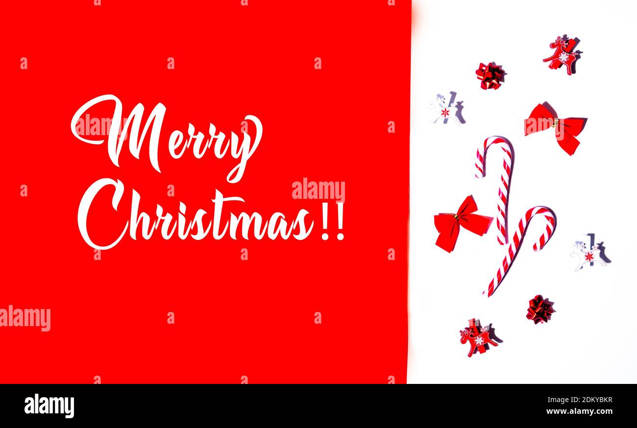 Merry Christmas text and christmas decorations isolated on red and white background. White text  isolated on red background. Christmas holidays. Stock Photo