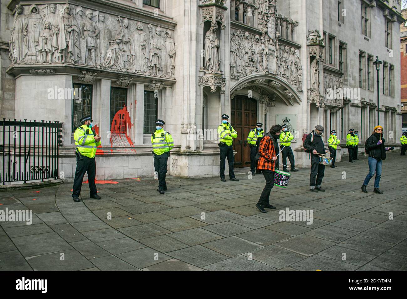 WESTMINSTER LONDON 16 December 2020.Police outside the Supreme Court after an environmental activist threw paint at the windows. Heathrow airport won a Supreme Court challenge over a ruling made earlier this year to block a third runway at Europe's busiest hub on environmental grounds as the highest court overturned a Court of Appeal ruling in February that the UK government had failed to take into account climate change commitments when it gave the green light for the third runway. Credit: amer ghazzal/Alamy Live News Stock Photo