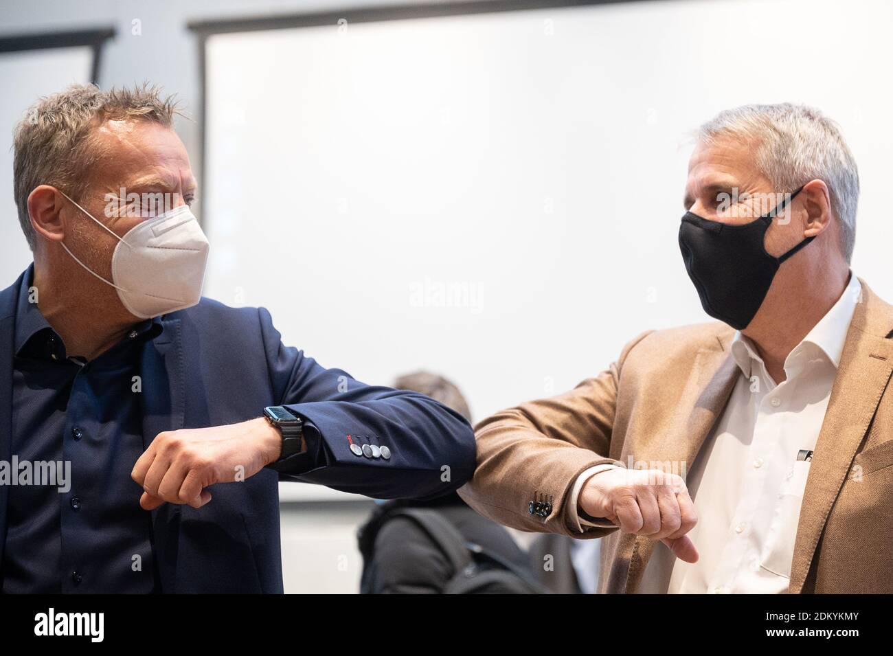 Stuttgart, Germany. 16th Dec, 2020. Wilfried Porth (r), chairman and negotiator of Südwestmetall, welcomes Roman Zitzelsberger, district manager and negotiator of IG Metall Baden-Württemberg, at the beginning of the collective bargaining for the metal and electrical industry in Baden-Württemberg. Credit: Sebastian Gollnow/dpa/Alamy Live News Stock Photo