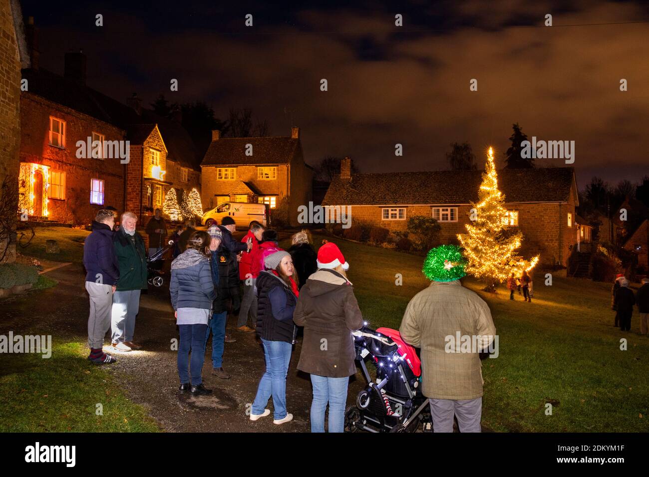 UK, England, Oxfordshire, Banbury, Wroxton, villagers gathering on village green to illuminate Christmas Tree Stock Photo