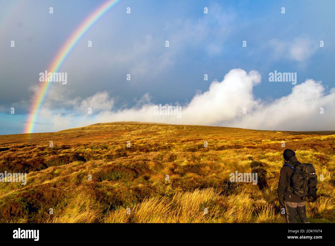 A hiker admiring a rainbow over the Pennine Way Stock Photo