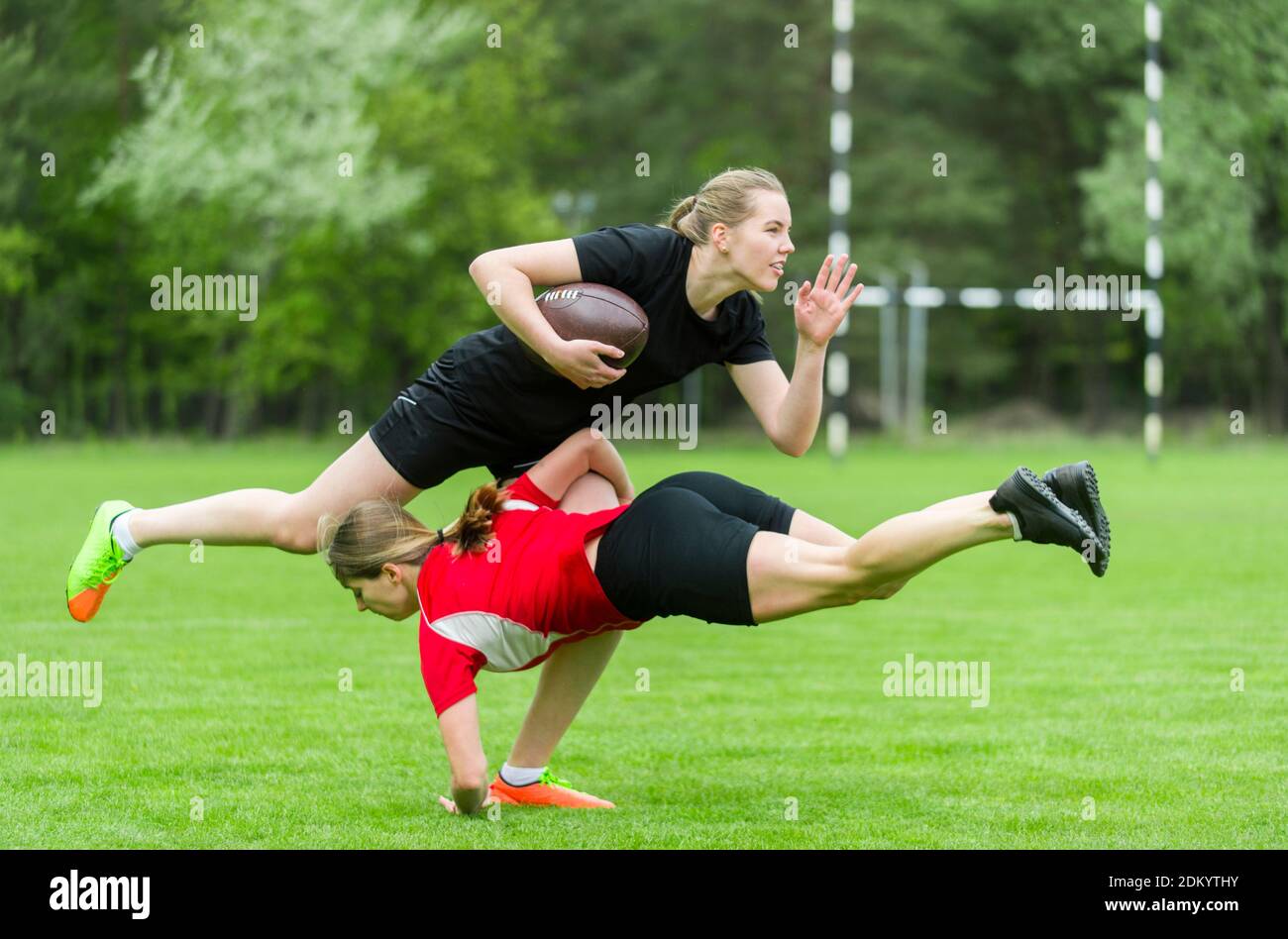 Female Rugby Player Tackling Opponent On Playing Field Stock Photo Alamy