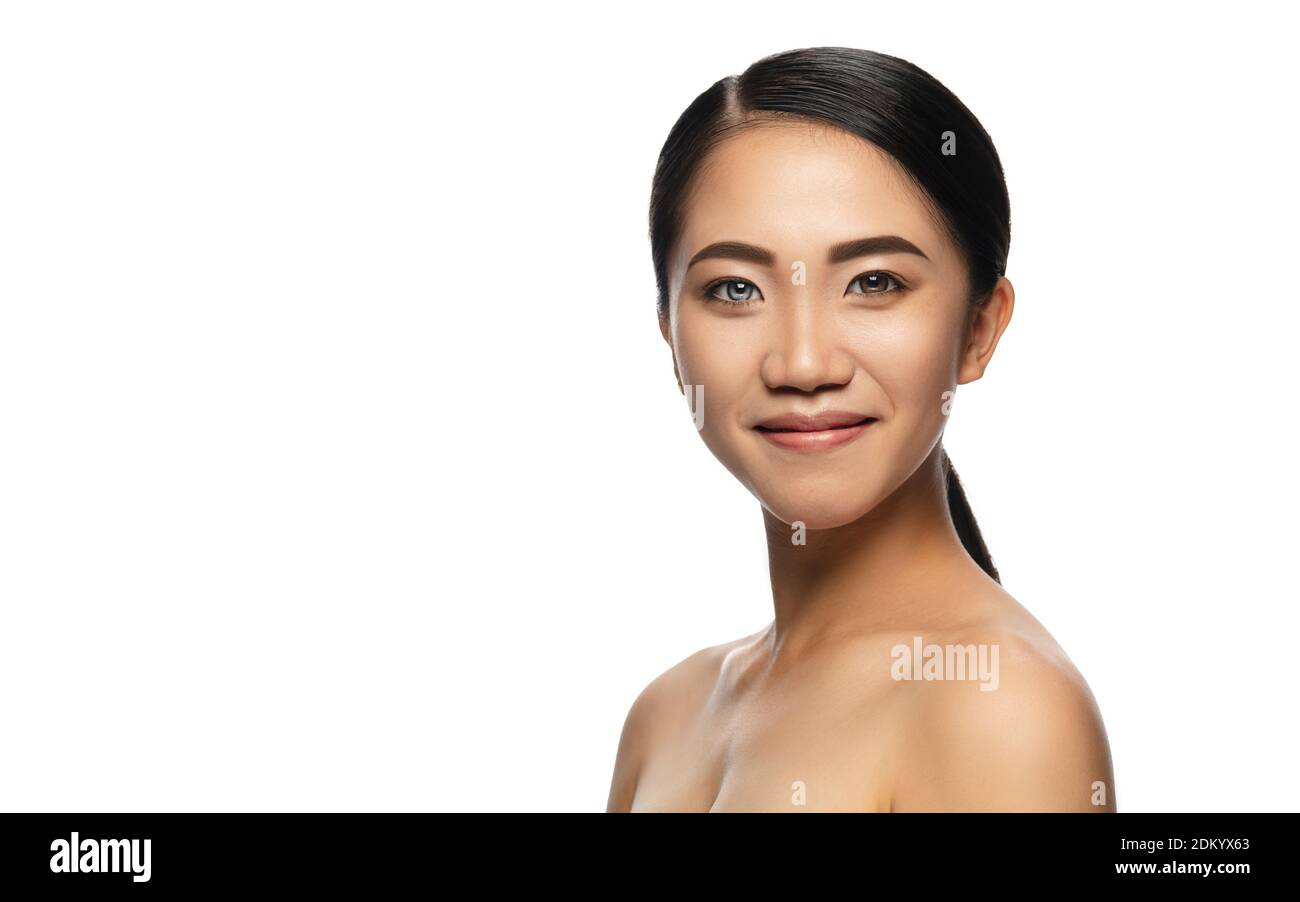 Beautiful asian woman with heterochromia isolated on white studio background. Copyspace for ad. Concept of beauty, fashion, healthcare, skincare. Complete special eyes colour, blue and brown. Stock Photo