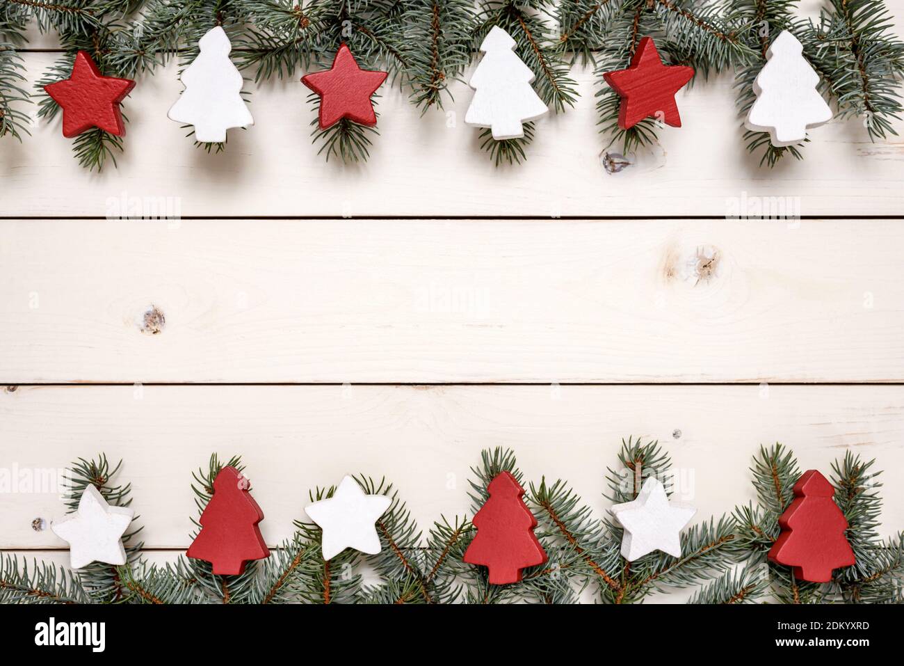 Christmas frame made of fir branches and wooden Christmas ornaments on ...