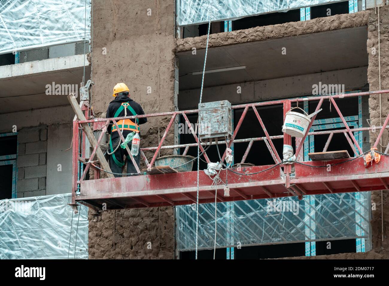Tbilisi, Georgia - 12 December, 2020: worker working at construction. Building structure on progress at site. Wearing proper safety gear Stock Photo