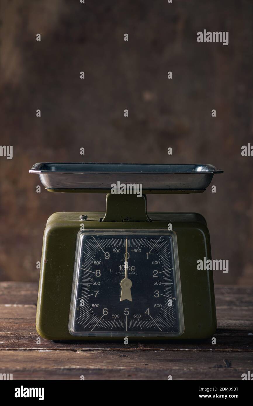 Green Vintage Scales on Wooden Table Stock Photo